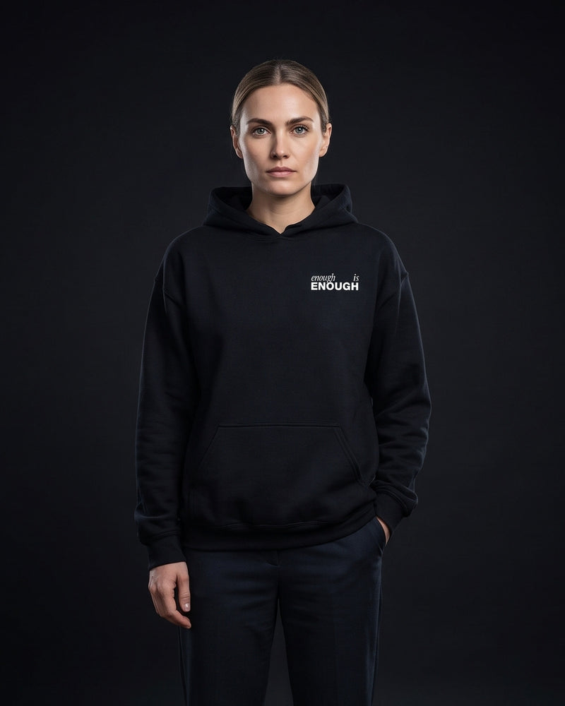 Frau trägt den WORN OPINIONS Hoodie Enough is enough in Schwarz, Brustprint enough is ENOUGH